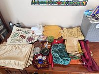 Overview of assorted placemats, napkins, coasters, candles and decorative pieces laid on table
