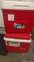 Two stacked red coolers showing overall condition