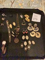 Entire assortment of jewelry and watch on black background