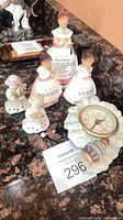 Group shot of all figurines and clock on countertop