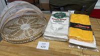 tray with mesh food cover and packaged tablecovers on workbench