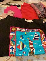 Black sequin-embellished sweater with folded pink, red and multicolour knits