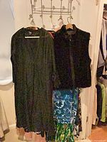 Group of garments including black sheer cardigan, black zip vest, tie-dye and patterned dresses