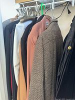 Rack showing multiple coats and blazers in assorted colors