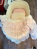 top view of wicker bassinet showing interior bedding
