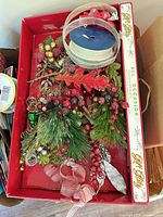 Tray showing wired ribbon spools and holiday decorative picks inside original All Occasion Gift Bags box
