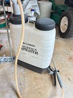 Front view of RL FloMaster backpack sprayer with hose and wand