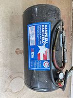 Overall view of Campbell Hausfeld portable air tank with hose and gauge