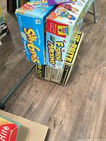 Stack showing Silly 6 Pins, Fishin’ Around and two Lite-Brite boxes