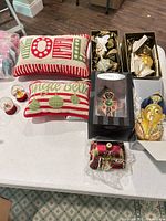 Overview of pillows and boxed ornaments on table