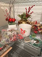 Lot overview on shelf showing vases, planters, bags of picks and floral tools
