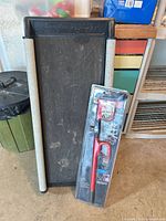 Steering wheel lock packaged and pet ramp standing against wall
