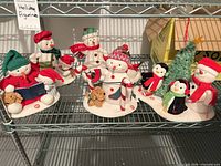 Full group of six Hallmark plush figurines on shelf