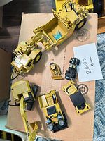 Group shot showing all four Caterpillar die-cast vehicles on box