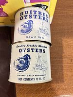 Two small oyster cans stacked showing labels and size information