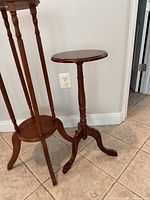 Tall four-leg plant stand and small tripod plant stand, brown wood finish