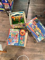 Railroad set box, tool workbench parts, Sesame Street books in boxes