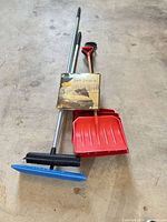 Overall view of snow broom, snow shovel and boxed windshield cover