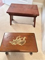 Two wooden step stools, front stool shows goose motif
