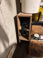 Front view of narrow solid wood cabinet showing three compartments