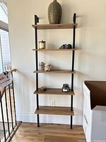 Front view of five-shelf wall unit showing overall design and materials