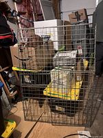 Front view of rectangular galvanized steel wire panels leaning against storage boxes