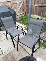 Both patio armchairs showing full frames, sling seats and backs