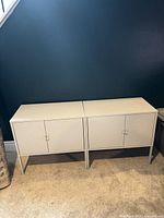 Two identical gray metal cabinets side-by-side against wall