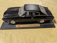 Full view of black 1:18 Maisto 1971 Chevelle on base