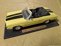 Left front three-quarter view of Maisto 1:18 Chevelle on display base