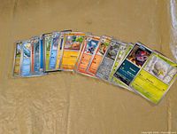 Fan layout of all 30 Pokémon cards on surface