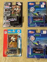 All four sealed Team Collectible packages