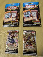 Front view of all four sealed Yu-Gi-Oh! packs