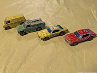 Group shot of all four Hot Wheels cars showing overall types and wear