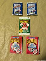 Five sealed 1991 baseball card packs arranged for overview