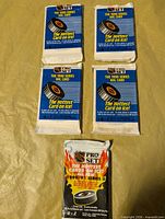 Front view showing four blue/white Series I packs and one black/flame Series II pack