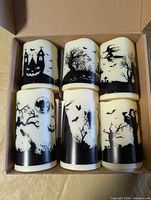 Box of six flameless Halloween candles showing various designs