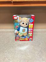 Front view of boxed CoComelon Boo Boo JJ plush doll