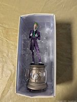 Figure in clamshell inside box showing Joker pose and base