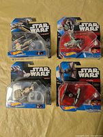 Group of four sealed Hot Wheels Star Wars starship packages