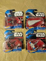 Group view of four sealed Hot Wheels Star Wars ships