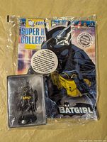 Sealed package showing figurine and magazine