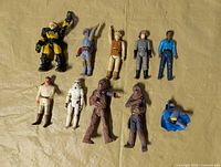 All ten action figures laid out on surface