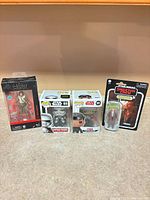 All four packaged figures standing side by side