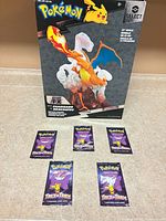 Front view of boxed Charizard figure and five booster packs