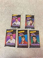 Front view of all five sealed packs showing different Elvis images