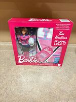 Front view of sealed Barbie Tim Hortons PWHL gift set showing doll and blanket inside box
