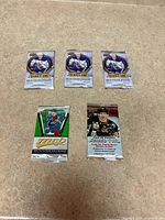 Five sealed Upper Deck hockey card packs laid out