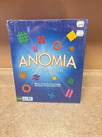 Front view of sealed Anomia Party Edition box