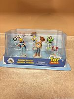 Front view of sealed Toy Story figurine playset showing all six figures inside blister packaging